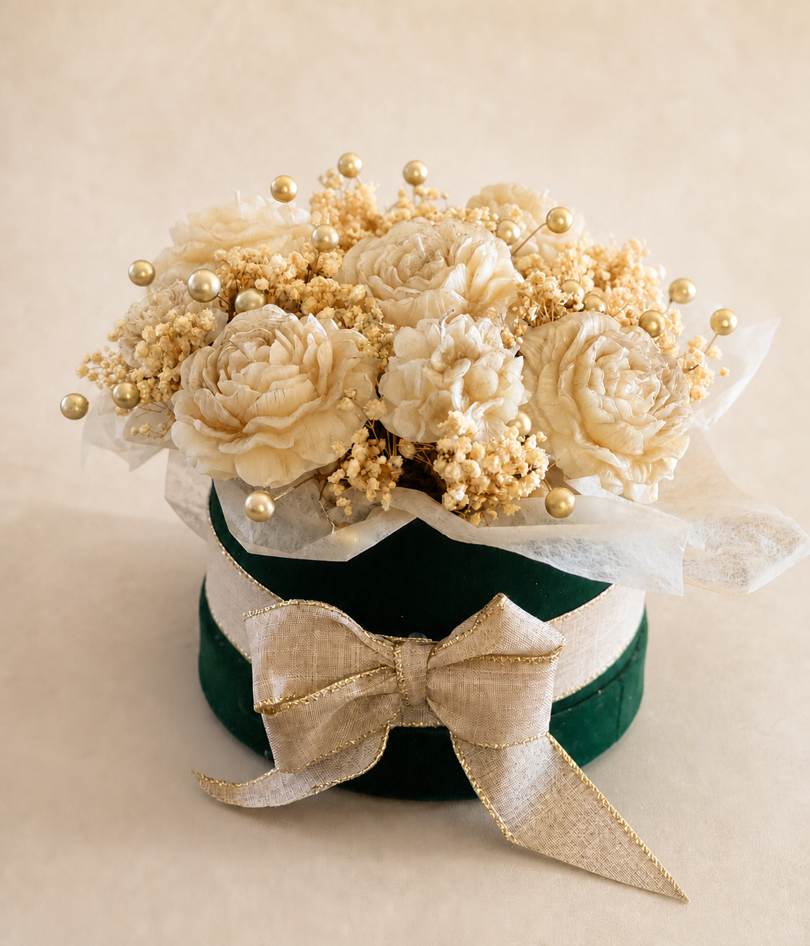 All-white nine-flower holiday candle bouquet in a green hatbox