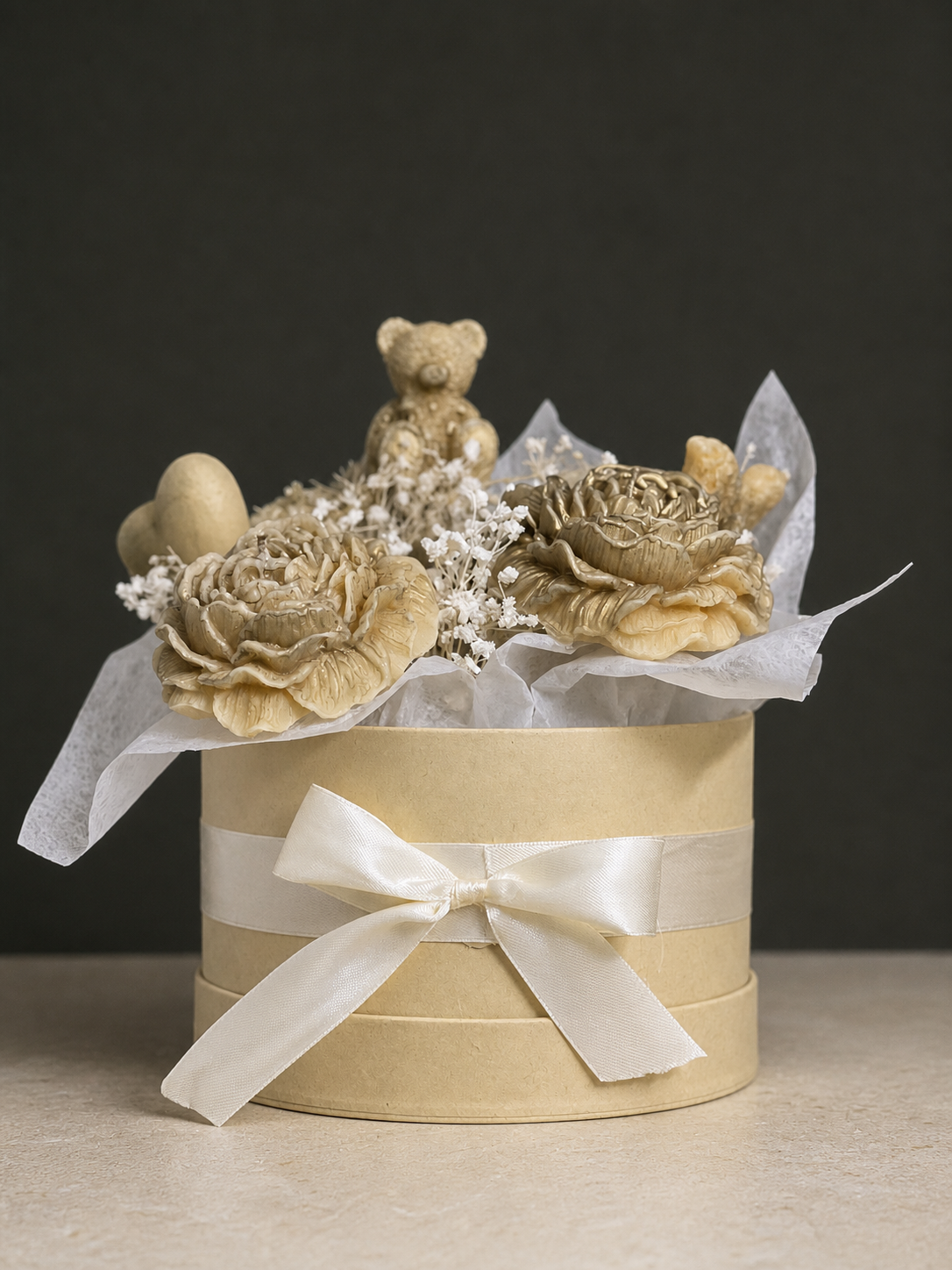 Ivory and gold teddy bear and flower candle gift arrangement in a hatbox