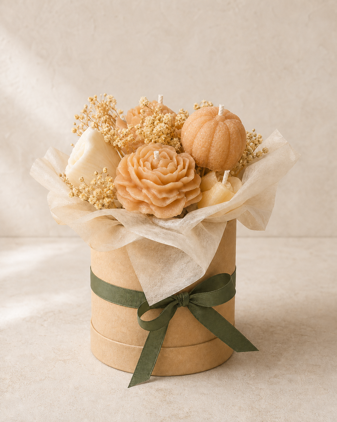 Peach and ivory floral candle bouquet with a pumpkin accent and olive ribbon