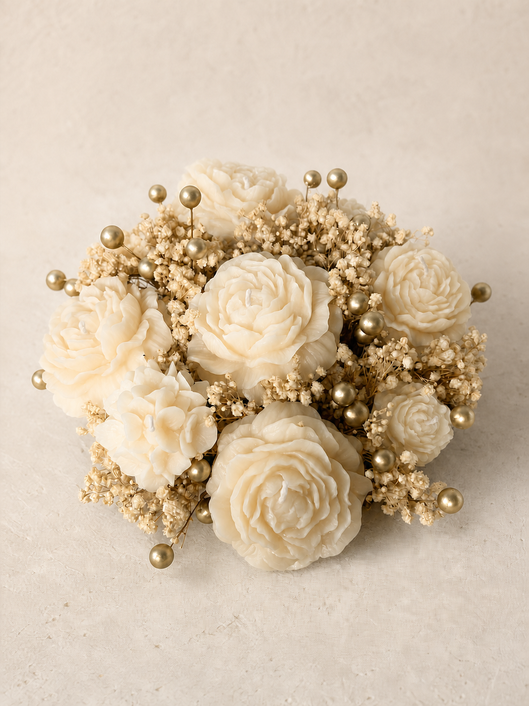 Ivory sculptural flower candle bouquet accented with gold berries
