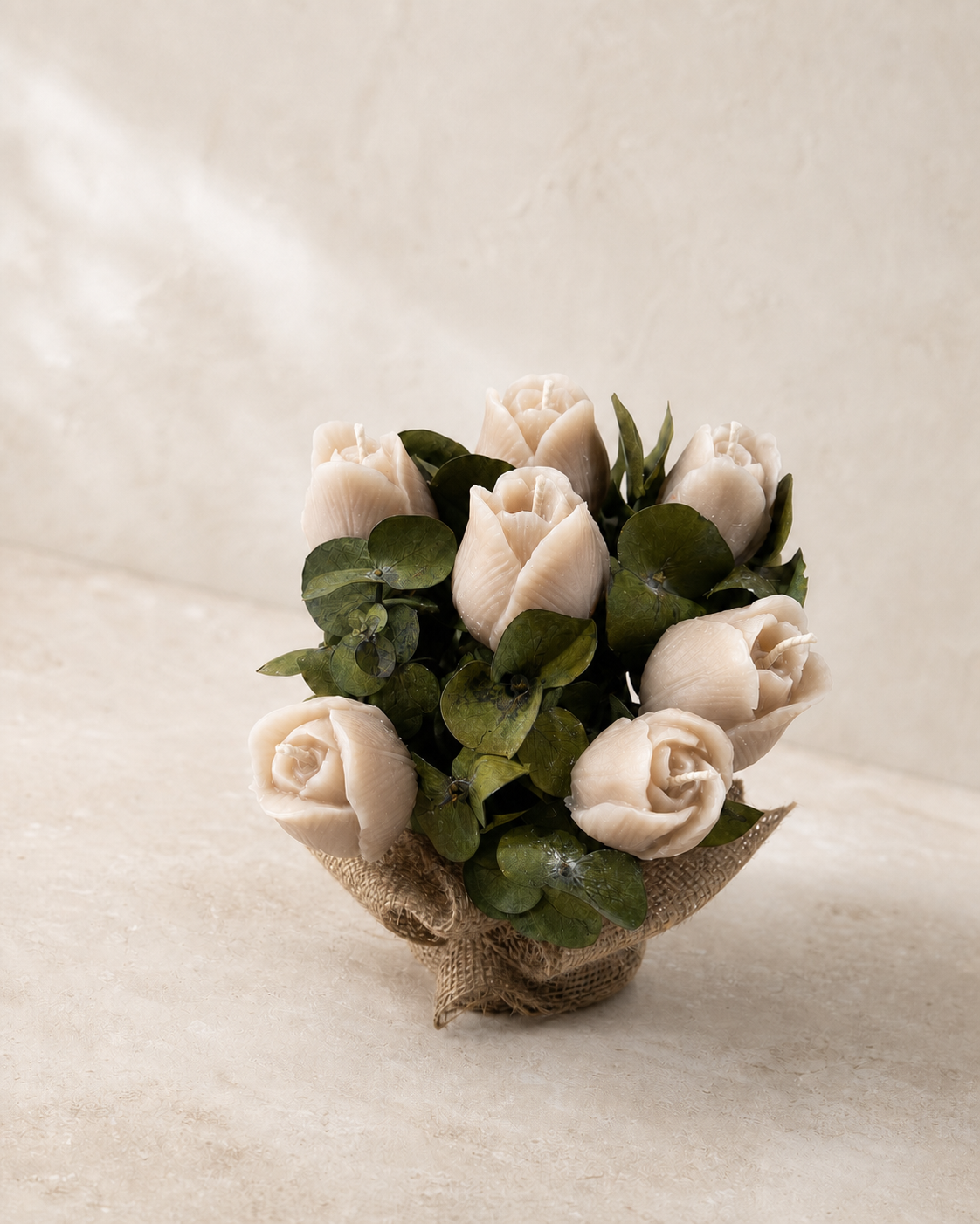 Ivory tulip and rose candles arranged with deep green eucalyptus